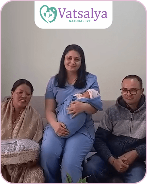 A family standing in front of Vatsalya sign